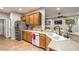 This bright kitchen features tile floors, wood cabinets, and stainless steel appliances at 2413 Hamonah Dr, Henderson, NV 89044
