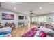 Bright living room featuring a ceiling fan, tile flooring, and large windows at 2413 Hamonah Dr, Henderson, NV 89044