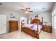 Spacious main bedroom featuring a four poster bed, dresser, and tile floors at 2413 Hamonah Dr, Henderson, NV 89044