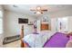 Inviting bedroom featuring neutral walls, a ceiling fan, and an ensuite bathroom with plentiful natural light at 2413 Hamonah Dr, Henderson, NV 89044