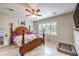Cozy main bedroom with ceiling fan, large windows, and four-poster bed at 2413 Hamonah Dr, Henderson, NV 89044