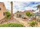 Backyard of home with utility installations surrounded by desert landscaping including greenery and roses at 2810 Lava Rock Ave, North Las Vegas, NV 89031