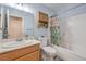 Traditional bathroom with wood vanity, shower-tub combo, and soft blue walls, perfect for a fresh start at 2810 Lava Rock Ave, North Las Vegas, NV 89031