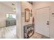 Inviting entryway with coat rack, neutral wall color, and view into the light-filled living spaces at 2810 Lava Rock Ave, North Las Vegas, NV 89031