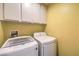 Modern laundry room featuring a front-load washer and dryer for convenient and efficient chores at 2810 Lava Rock Ave, North Las Vegas, NV 89031