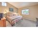 Bright main bedroom with plush carpeting and a window offering backyard views at 2810 Lava Rock Ave, North Las Vegas, NV 89031