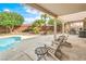 Relaxing covered patio with pool access and comfortable seating, perfect for outdoor entertaining and enjoying the backyard oasis at 2810 Lava Rock Ave, North Las Vegas, NV 89031
