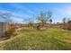 Large backyard with mature trees offering shade, a swing set, and ample space for recreation and relaxation at 319 Belfast St, Henderson, NV 89015