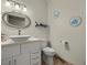 Bright bathroom featuring a modern vanity and decorative nautical-themed wall art at 319 Belfast St, Henderson, NV 89015