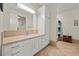 Bathroom featuring a sink, vanity, and a separate shower area, tiled walls, and marble flooring at 319 Belfast St, Henderson, NV 89015