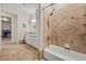 Bathroom with a shower and bathtub featuring white cabinets and a tiled floor at 319 Belfast St, Henderson, NV 89015