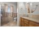 Bathroom featuring a tiled floor, wood cabinet vanity, toilet and tile shower with a curtain at 319 Belfast St, Henderson, NV 89015