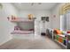 Cozy bedroom with a bunk bed, desk, and window seat, creating a functional and inviting space at 319 Belfast St, Henderson, NV 89015