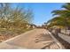 Paver driveway leading to charming single-story home with mature landscaping and an inviting curb appeal at 319 Belfast St, Henderson, NV 89015