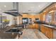 Well-equipped kitchen featuring stainless steel appliances, a cooktop island, and wooden cabinetry at 319 Belfast St, Henderson, NV 89015