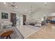 Bright and airy living room with vaulted ceilings, an area rug, and a seamless transition to the kitchen at 319 Belfast St, Henderson, NV 89015