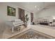 Elegant living area featuring a piano, vaulted ceilings, stylish decor, and abundant natural light at 319 Belfast St, Henderson, NV 89015