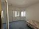 Bedroom featuring two windows with blinds, a closet and carpeted floors at 3213 Partridge Run St, Laughlin, NV 89029
