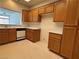 Spacious kitchen with oak cabinets, white countertops and appliances at 3213 Partridge Run St, Laughlin, NV 89029