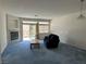 Bright living room with cozy fireplace, large windows, and comfortable carpet flooring at 3213 Partridge Run St, Laughlin, NV 89029