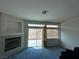 Bright living room with cozy fireplace, large windows, and comfortable carpet flooring at 3213 Partridge Run St, Laughlin, NV 89029