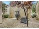 Small backyard features desert landscaping with a small patio at 3650 Mcmurty Ct, Las Vegas, NV 89129