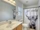 Bathroom features a single sink vanity with a shower and tub combo with fun shower curtain at 3650 Mcmurty Ct, Las Vegas, NV 89129
