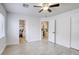 Bright bedroom features a ceiling fan, two windows with wood-look laminate flooring at 3650 Mcmurty Ct, Las Vegas, NV 89129
