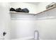 Walk in closet features wood laminate floors, white walls and corner shelves with bars for hanging clothing at 3650 Mcmurty Ct, Las Vegas, NV 89129