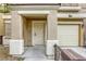Close-up of a home's entrance, highlighting the front door, trim and single car garage at 3650 Mcmurty Ct, Las Vegas, NV 89129
