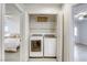 Convenient laundry closet with a stacked washer and dryer, next to the main bedroom at 3650 Mcmurty Ct, Las Vegas, NV 89129