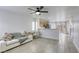 Bright living room with a modern sofa, desk, and an open view of the kitchen and outdoor access at 3650 Mcmurty Ct, Las Vegas, NV 89129