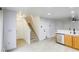 Bright, open-concept living room features hardwood floors, staircase, and stainless steel dishwasher at 3650 Mcmurty Ct, Las Vegas, NV 89129