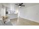 Bright living room with a modern sofa, desk, and an open view of the kitchen and outdoor access at 3650 Mcmurty Ct, Las Vegas, NV 89129
