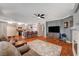 Cozy living room featuring hardwood floors, a fireplace, and an open kitchen at 3734 John Bailey St, Las Vegas, NV 89129