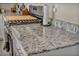 Kitchen detail showcasing granite countertops and stainless steel appliances at 3760 Seyfert Ave, North Las Vegas, NV 89084