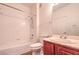 Bathroom with a tub, cherry wood cabinets, framed mirror and brushed nickel hardware at 3925 Lazy Pine St # 204, Las Vegas, NV 89108