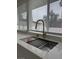 Close-up of kitchen sink with high-end faucet and accessories with exterior view at 4054 Venita Ct, Las Vegas, NV 89120