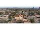 Expansive aerial view of a residential neighborhood with city skyline views, featuring a variety of single-Gathering homes and mature trees at 4300 Del Monte Ave, Las Vegas, NV 89102