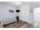 Bedroom features wood-look floors, a ceiling fan, closet doors, and a TV on the wall at 4300 Del Monte Ave, Las Vegas, NV 89102