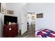A bedroom featuring wood-look floors, a dresser with a TV, and artwork at 4300 Del Monte Ave, Las Vegas, NV 89102