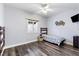 Comfortable bedroom with a twin bed, ceiling fan, light wood floors, and natural light at 4300 Del Monte Ave, Las Vegas, NV 89102