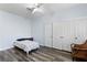 A simple bedroom boasts wood-look floors, a ceiling fan, and a closet with sliding doors at 4300 Del Monte Ave, Las Vegas, NV 89102