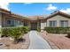 Close-up of a home's entrance, featuring a tiled roof, a decorative security door, and manicured landscaping at 4300 Del Monte Ave, Las Vegas, NV 89102