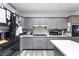 Gray kitchen with black stainless steel appliances and stone backsplash at 4300 Del Monte Ave, Las Vegas, NV 89102