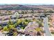 Wide aerial of a neighborhood showcasing a mix of houses, pools, landscaping, and mountain views at 4481 Grey Spencer Dr, Las Vegas, NV 89141