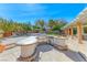 Backyard featuring built in kitchen, barbeque, pool, desert landscaping, and covered patio at 4481 Grey Spencer Dr, Las Vegas, NV 89141