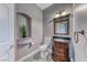 Half bathroom featuring elegant vanity, decorative mirror, toilet, and gray walls and tile floor at 4481 Grey Spencer Dr, Las Vegas, NV 89141