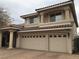 Tan stucco home with a tile roof, a two-car garage, and brick paver driveway at 4481 Grey Spencer Dr, Las Vegas, NV 89141