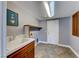 Laundry room with utility sink, washer/dryer hookups, built in cabinets, and light tile floor at 4481 Grey Spencer Dr, Las Vegas, NV 89141